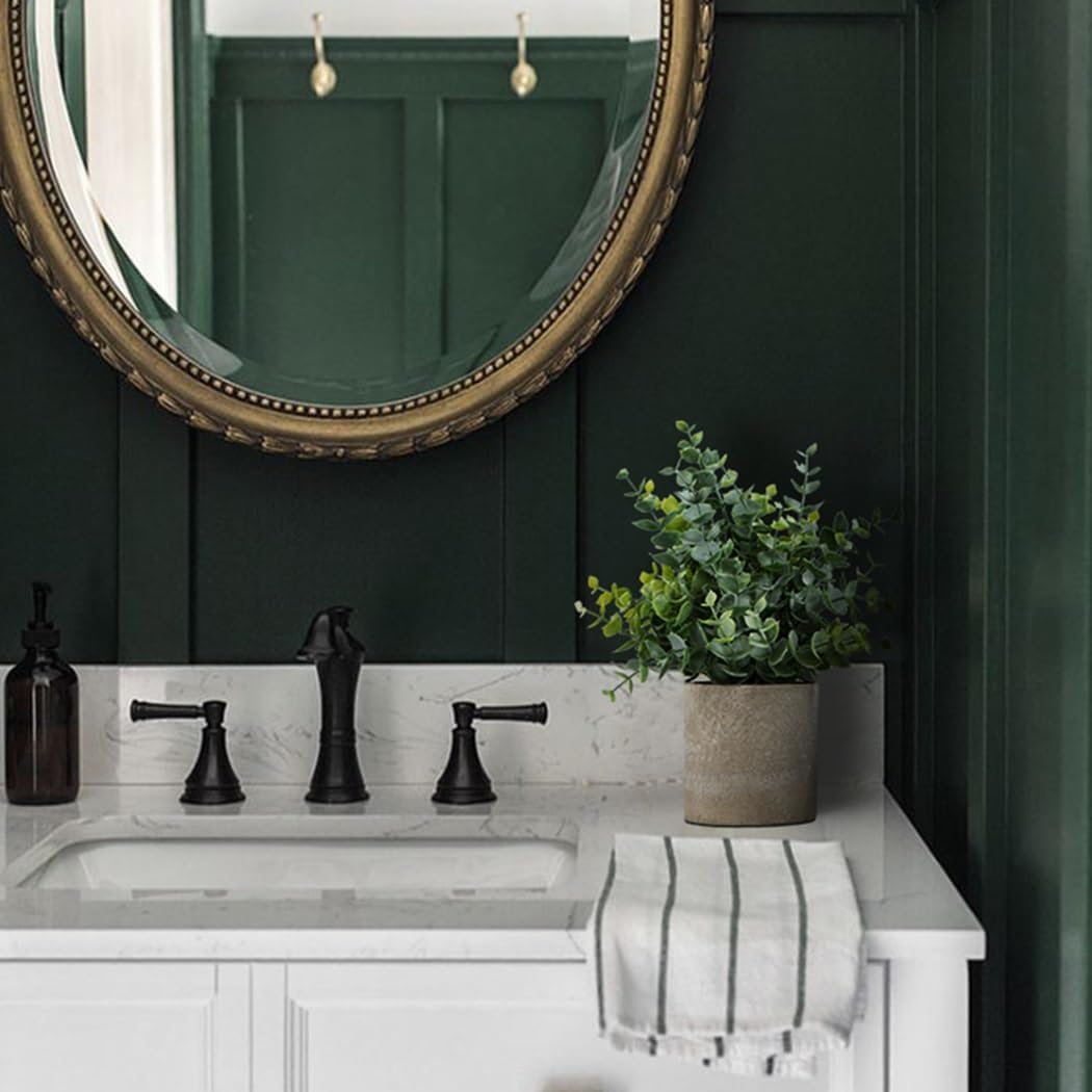 Fixtur Services artificial eucalyptus plants in a modern bathroom setting with a round mirror
