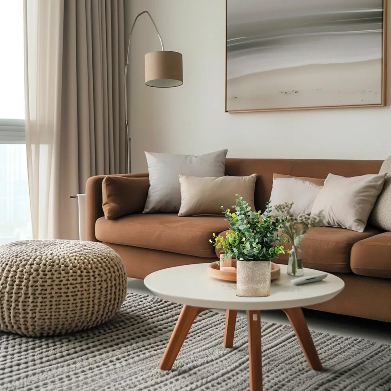 Stylish living room featuring artificial eucalyptus plants in a decorative pot on a coffee table