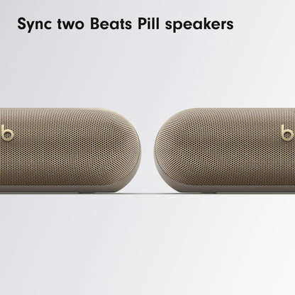 Two Beats Pill Bluetooth Speakers in Gold Syncing for Enhanced Sound Experience