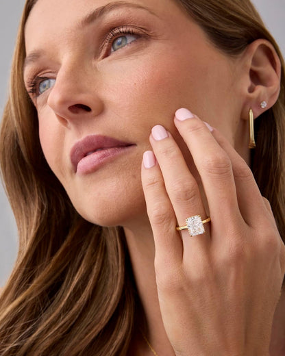 Model wearing a 14K gold plated engagement ring featuring a stunning center stone and elegant design