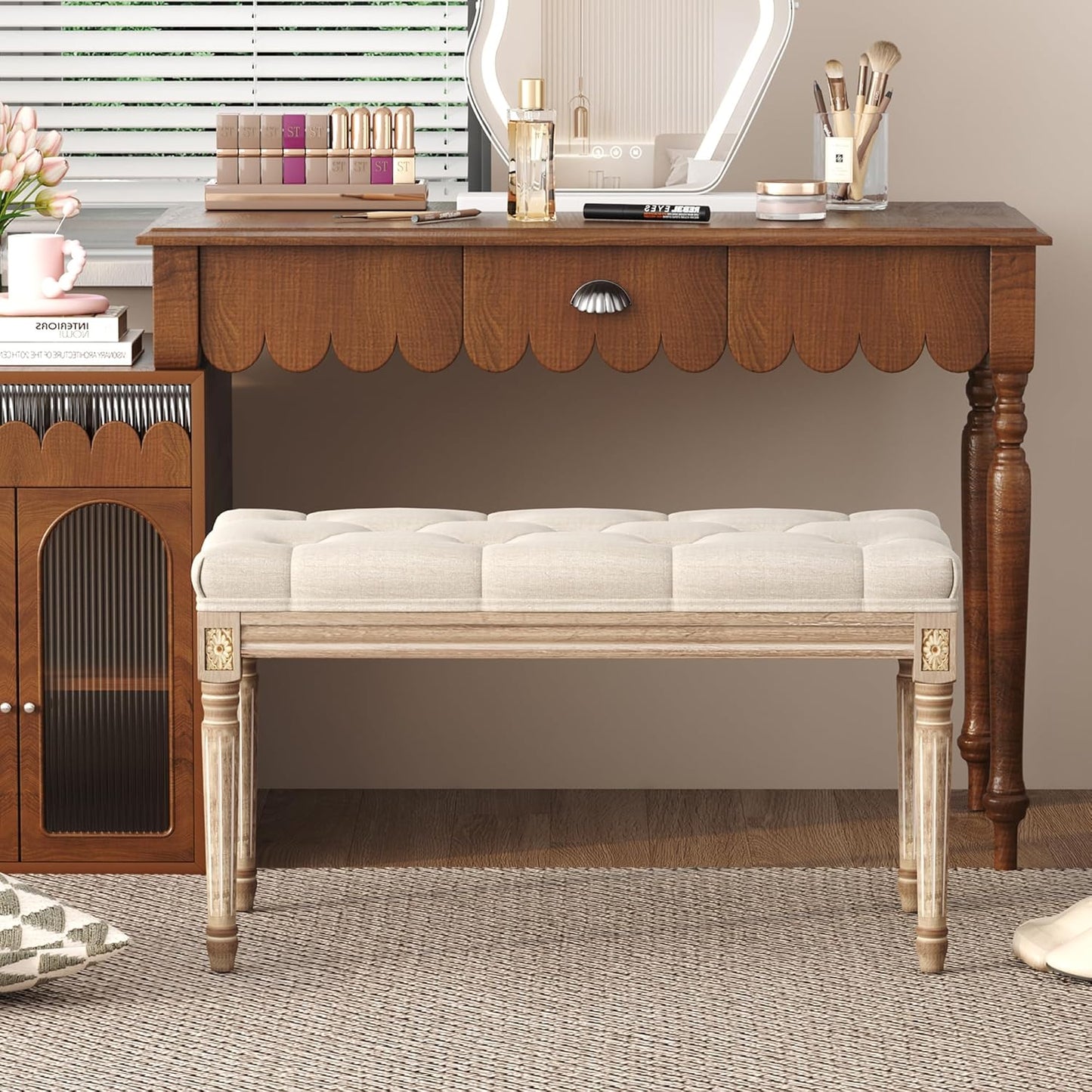 Elegant upholstered bedroom bench placed beside a stylish vanity in a chic bedroom setting