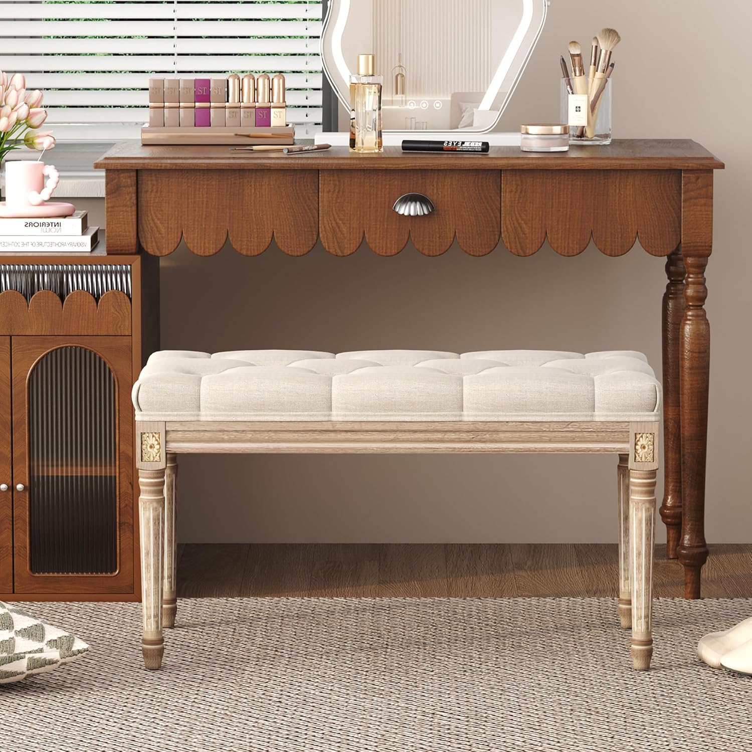 Elegant upholstered bedroom bench placed beside a stylish vanity in a chic bedroom setting